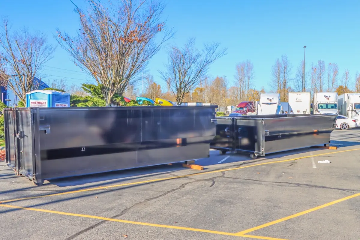 Professional dumpster rental service with roll-off container on residential driveway in Herkimer